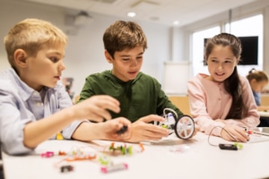 happy kid building robots at robotics school